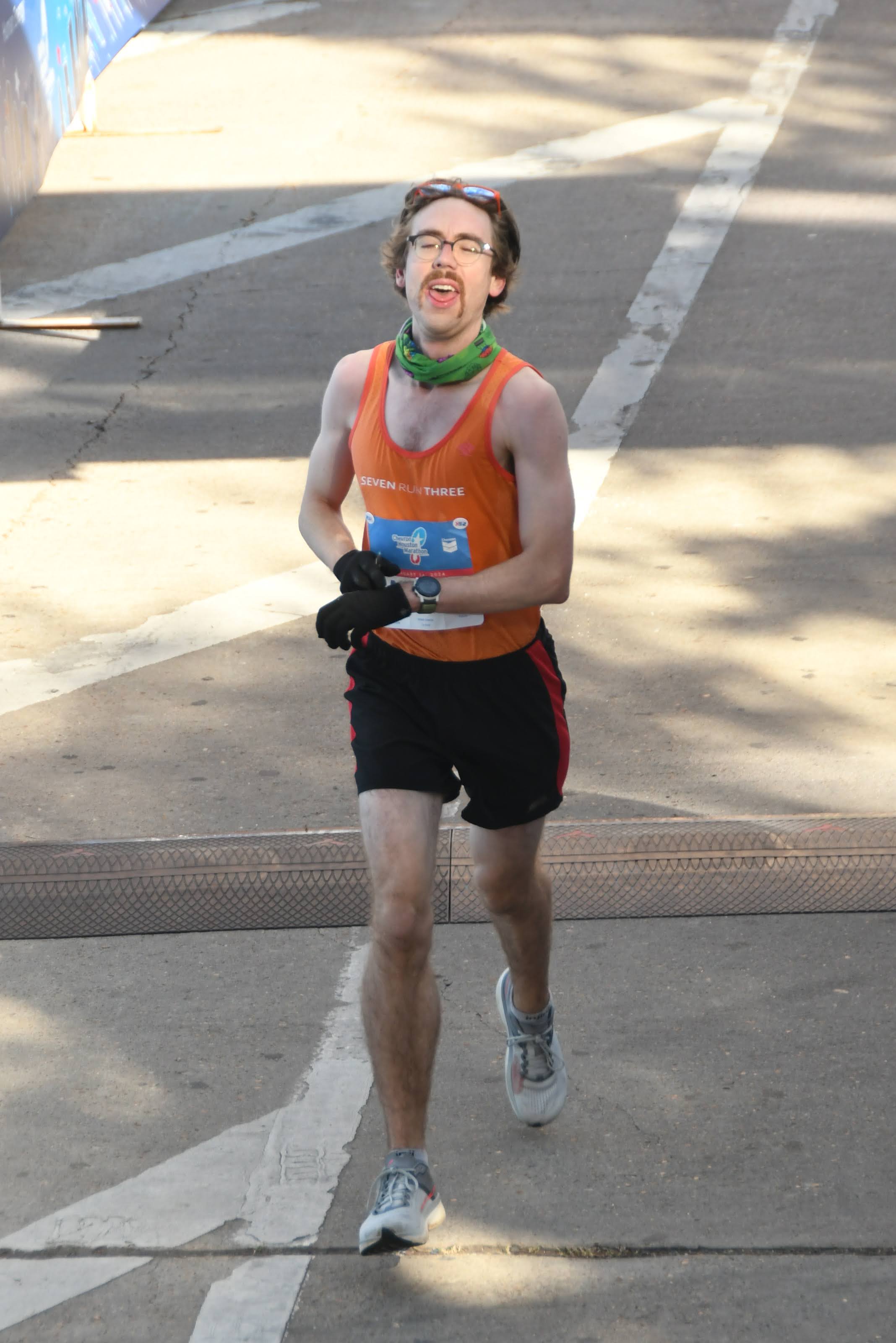 Man crossing the marathon finish line