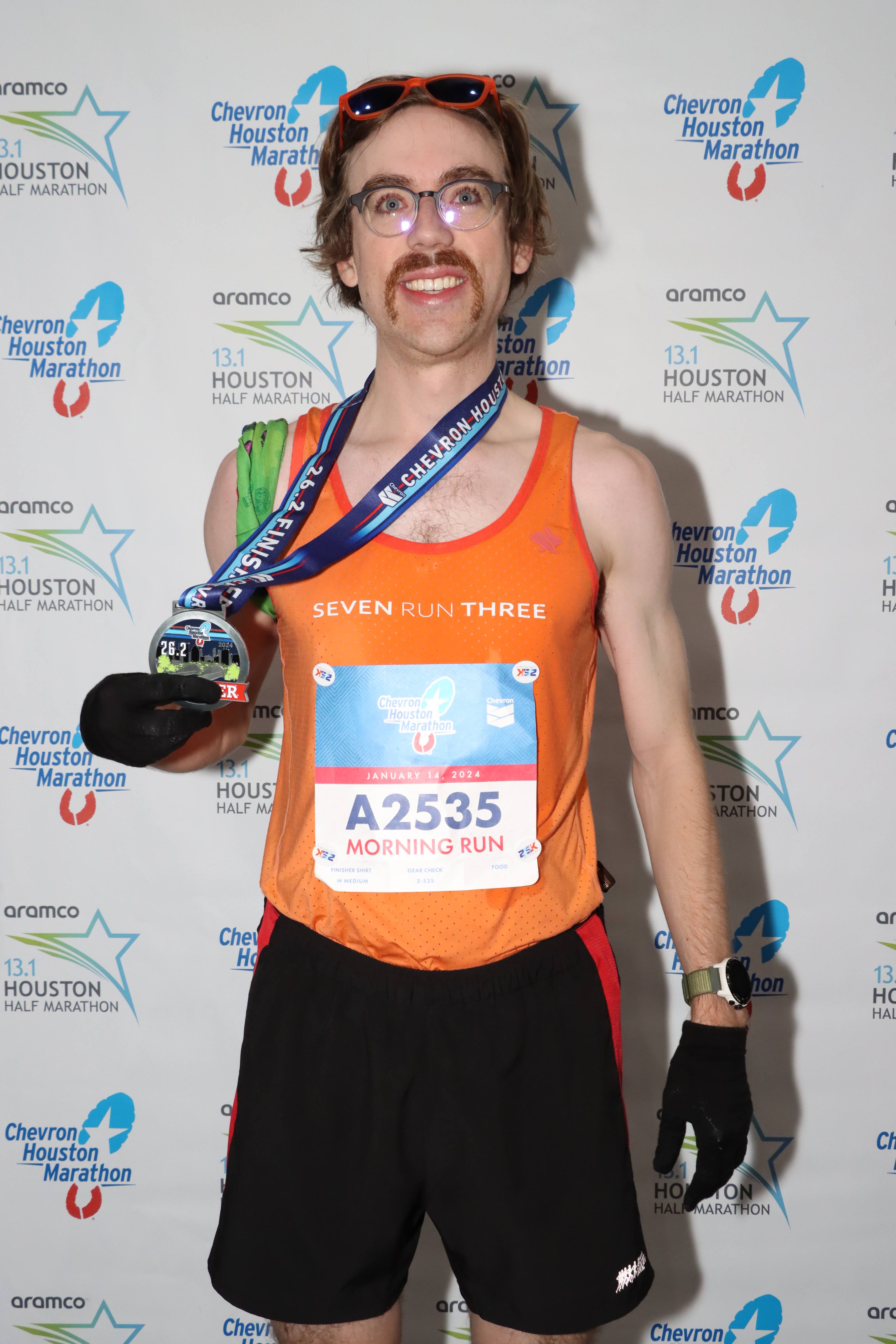 Man standing with marathon medal