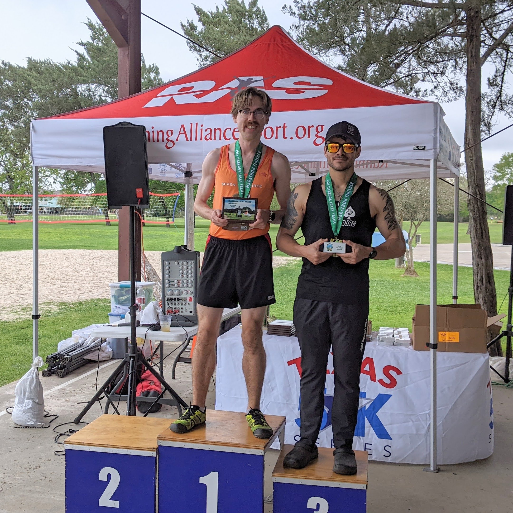 men standing on marathon finish podeum